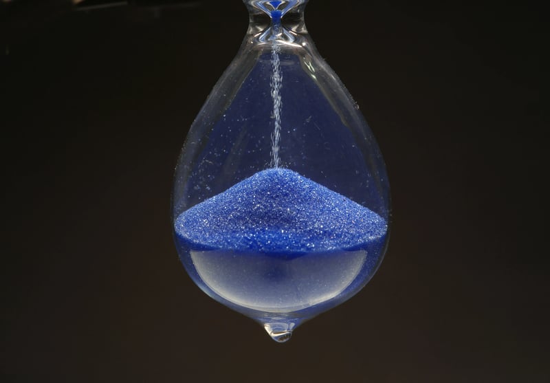 An hourglass and a clock symbolizing the passage of time for EtG detection