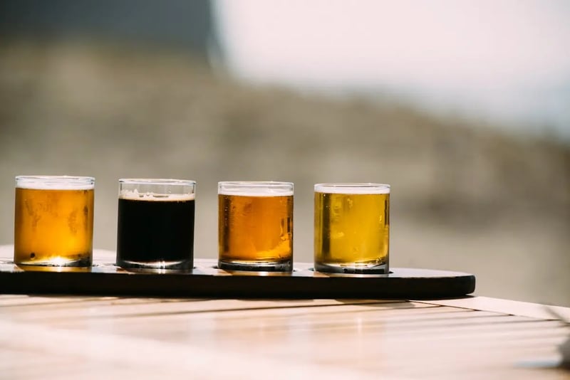 Assorted glasses filled with different alcoholic drinks on a bar counter